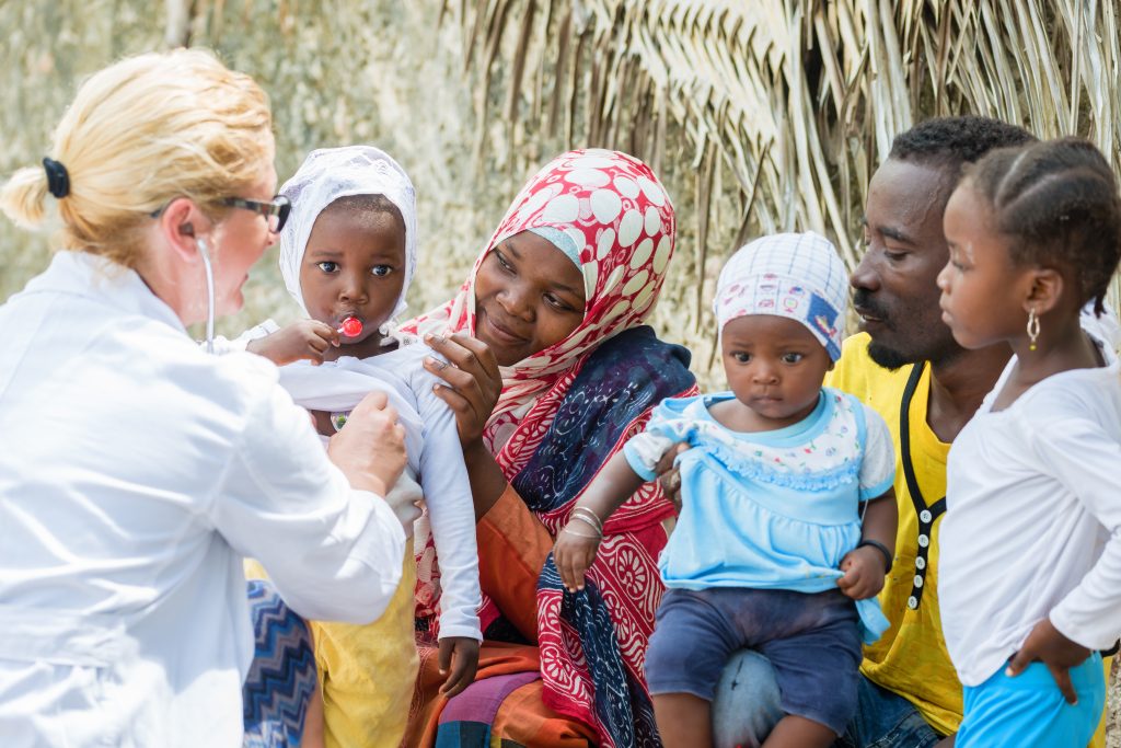 female doctors helping african family